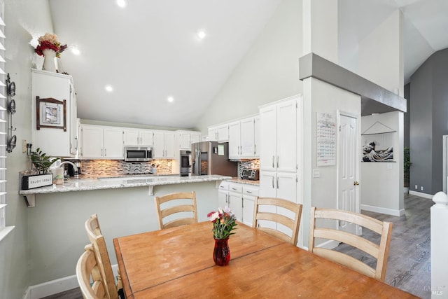 1105 Coulter Ct, Fairfield, CA 94533 - dining area with high vaulted ceiling, wood finished floors, and recessed lighting