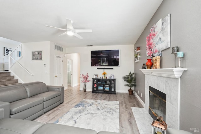 1105 Coulter Ct, Fairfield, CA 94533 - living room with a ceiling fan, wood finished floors, a high end fireplace, and stairway