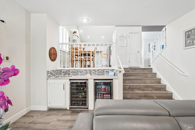 1105 Coulter Ct, Fairfield, CA 94533 - indoor bar featuring wine cooler, light wood-style floors, recessed lighting, and stairway