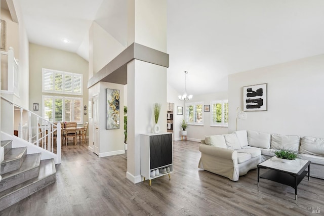 1105 Coulter Ct, Fairfield, CA 94533 - living area featuring high vaulted ceiling, a chandelier, wood finished floors, and stairway