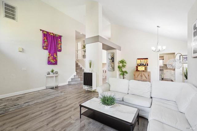 1105 Coulter Ct, Fairfield, CA 94533 - living area with vaulted ceiling, a chandelier, wood finished floors, and stairs