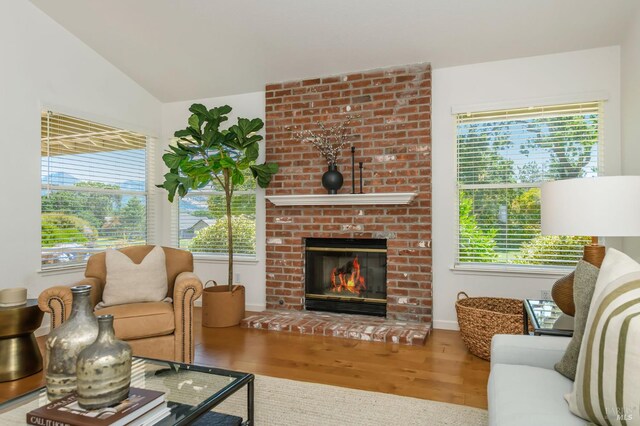 378 Miramonte Pl, Santa Rosa, CA 95409 - living area featuring wood finished floors, plenty of natural light, vaulted ceiling, and a brick fireplace