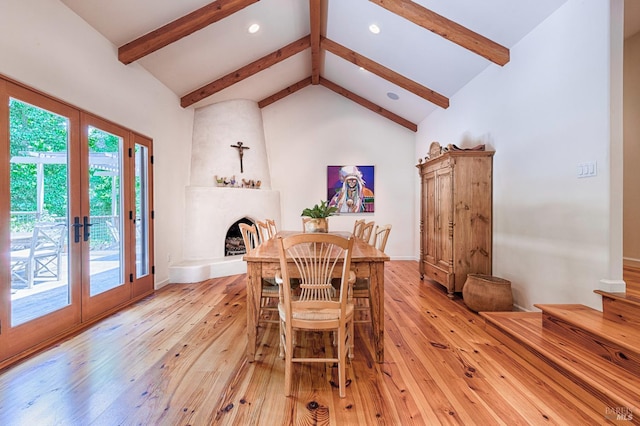 616 Wild Oak Dr, Santa Rosa, CA 95409 - dining room featuring french doors, beamed ceiling, light wood-style flooring, a large fireplace, and high vaulted ceiling