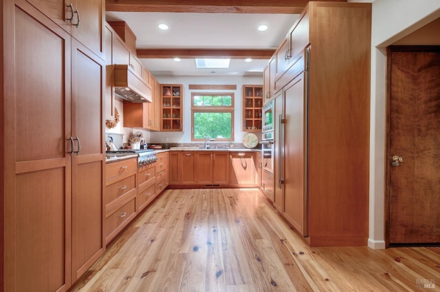 616 Wild Oak Dr, Santa Rosa, CA 95409 - kitchen featuring light wood-type flooring, custom exhaust hood, glass insert cabinets, light countertops, and appliances with stainless steel finishes