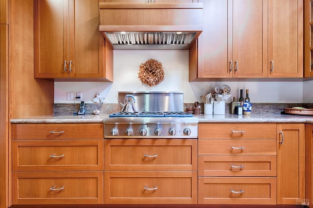 616 Wild Oak Dr, Santa Rosa, CA 95409 - kitchen with premium range hood, stainless steel gas cooktop, brown cabinets, and light stone counters