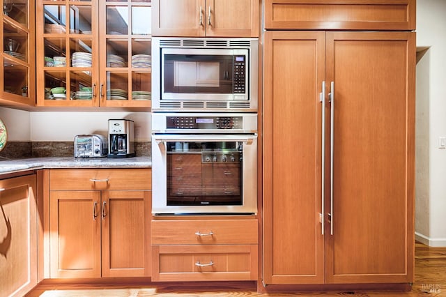 616 Wild Oak Dr, Santa Rosa, CA 95409 - kitchen with built in appliances, glass insert cabinets, light wood-style floors, and stone countertops
