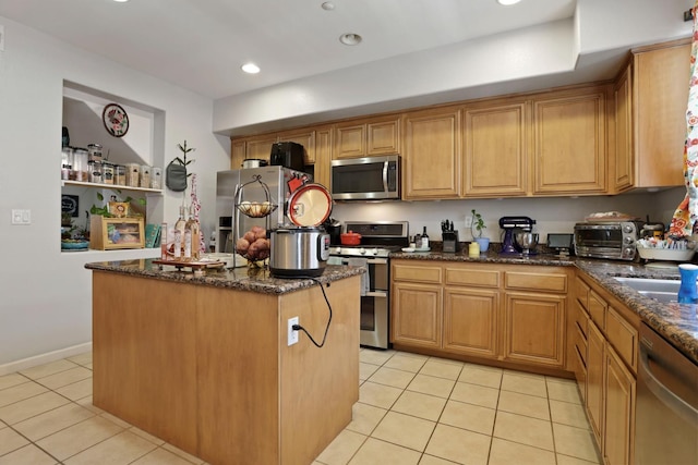 1756 Camino Real Way, Roseville, CA 95747 - kitchen with appliances with stainless steel finishes, light tile patterned floors, a center island, dark stone counters, and recessed lighting