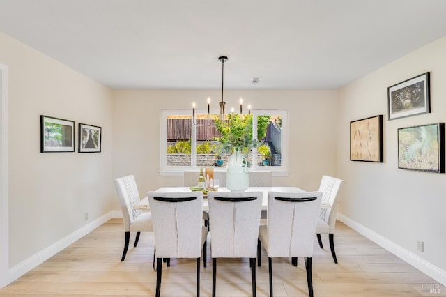 510 Hastings Dr, Benicia, CA 94510 - dining space with light wood-style floors and a chandelier