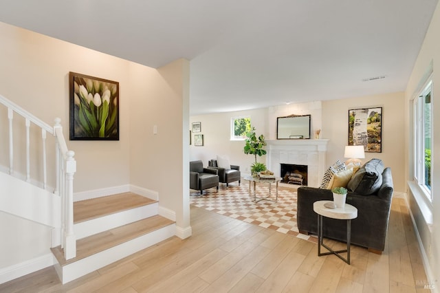 510 Hastings Dr, Benicia, CA 94510 - living room with stairs, light wood-style floors, a fireplace, and healthy amount of natural light