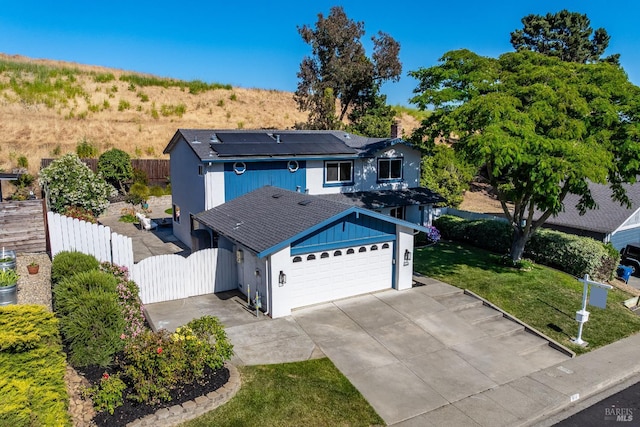 510 Hastings Dr, Benicia, CA 94510 - view of front of home featuring solar panels, a garage, a gate, driveway, and roof with shingles