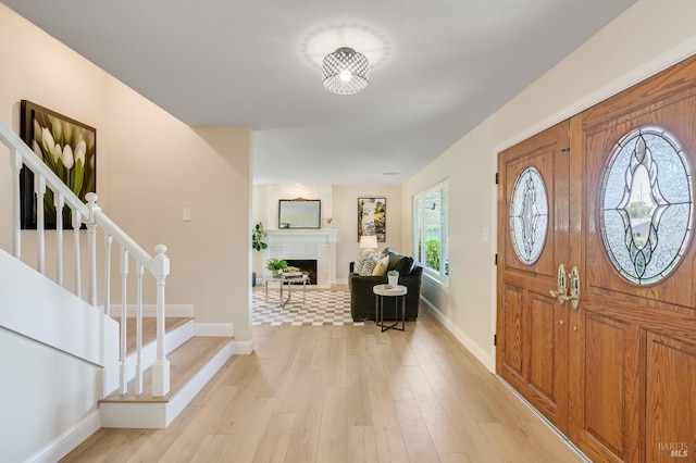 510 Hastings Dr, Benicia, CA 94510 - entryway featuring stairs, light wood-style flooring, and a fireplace