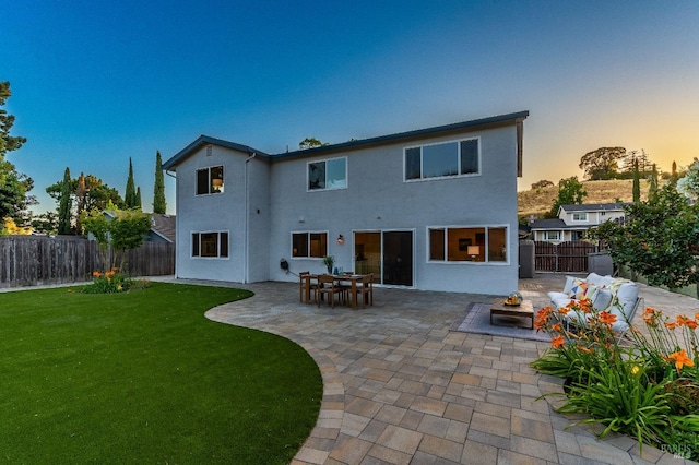 510 Hastings Dr, Benicia, CA 94510 - back of house at dusk with a patio, a fenced backyard, and stucco siding