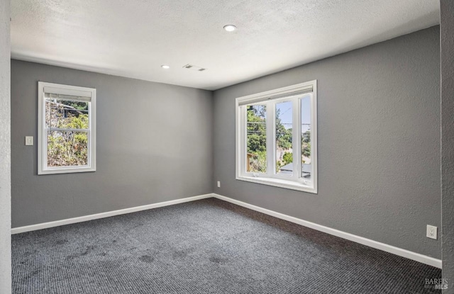 31 Buckelew St, Sausalito, CA 94965 - empty room featuring a textured wall, dark carpet, and recessed lighting