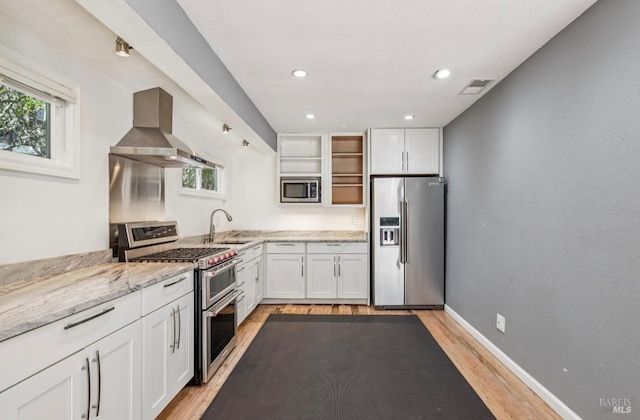 31 Buckelew St, Sausalito, CA 94965 - kitchen featuring appliances with stainless steel finishes, extractor fan, open shelves, light wood-style floors, and white cabinetry