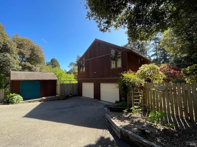 32691 Pearl Dr, Fort Bragg, CA 95437 - view of home's exterior with asphalt driveway and a storage shed