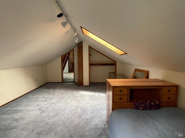 32691 Pearl Dr, Fort Bragg, CA 95437 - carpeted bedroom with rail lighting, a skylight, and vaulted ceiling