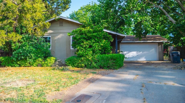 1701 Palm Pl, Davis, CA 95618 - view of front of house featuring a garage, stucco siding, and driveway