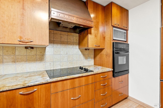 1288 Triple Oak Way, Fulton, CA 95439 - kitchen with black appliances, premium range hood, light stone counters, and brown cabinets