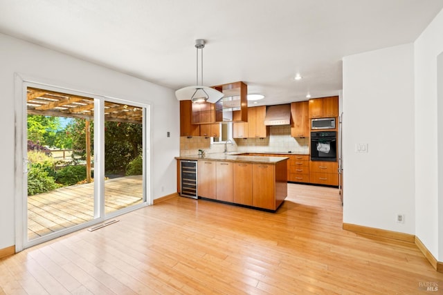 1288 Triple Oak Way, Fulton, CA 95439 - kitchen with black oven, stainless steel microwave, custom exhaust hood, a peninsula, and beverage cooler