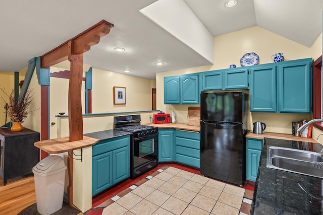 5338 Deception River Rd, Chico, CA 95928 - kitchen featuring black appliances, blue cabinets, recessed lighting, vaulted ceiling, and light tile patterned floors