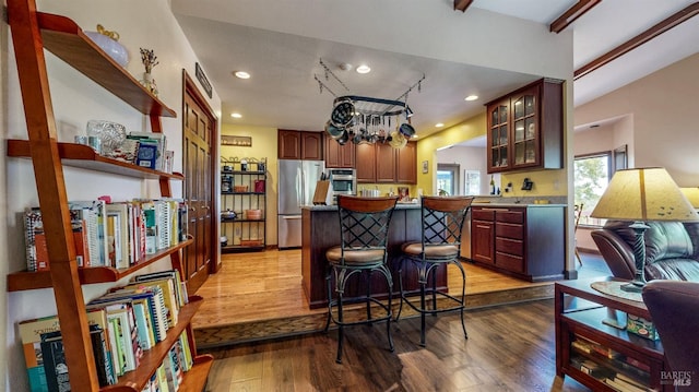 4389 Summit View Ranch Rd, Santa Rosa, CA 95404 - kitchen featuring appliances with stainless steel finishes, wood finished floors, glass insert cabinets, a kitchen breakfast bar, and a center island