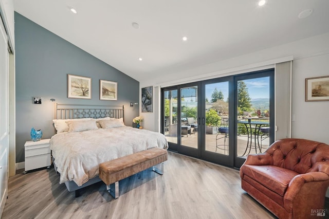 bedroom with french doors, access to outside, wood finished floors, high vaulted ceiling, and recessed lighting