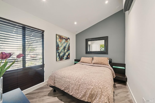 bedroom with light wood-type flooring, lofted ceiling, and recessed lighting