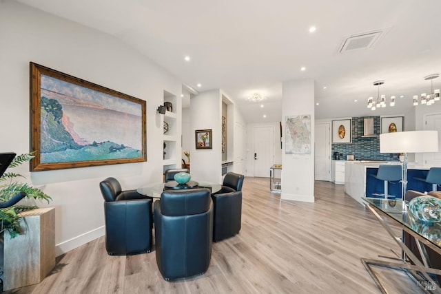 living room featuring a chandelier, light wood-style floors, and recessed lighting