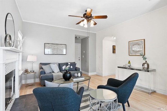 159 Suncliff Pl, Vallejo, CA 94591 - living room featuring arched walkways, a tiled fireplace, wood finished floors, ceiling fan, and crown molding