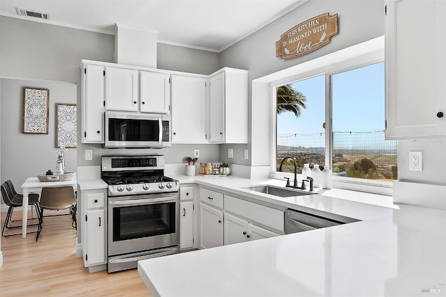 159 Suncliff Pl, Vallejo, CA 94591 - kitchen featuring appliances with stainless steel finishes, ornamental molding, light countertops, white cabinetry, and light wood-style floors