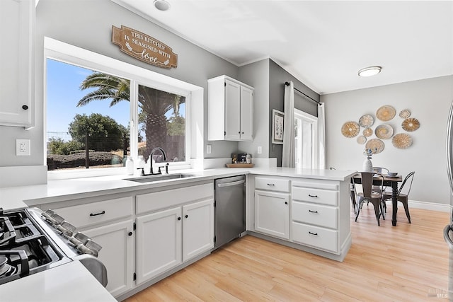 159 Suncliff Pl, Vallejo, CA 94591 - kitchen featuring stainless steel dishwasher, a peninsula, range, white cabinets, and light wood-style floors