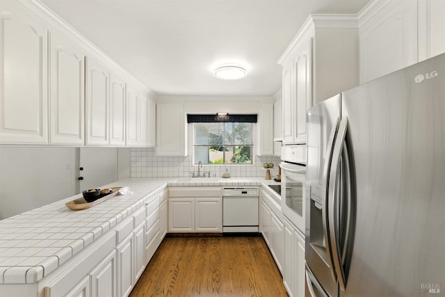 7 Arlene Ct, Petaluma, CA 94952 - kitchen featuring white appliances, tile countertops, white cabinets, and dark wood finished floors