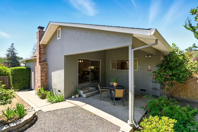 7 Arlene Ct, Petaluma, CA 94952 - rear view of property featuring stucco siding, a patio, and a chimney
