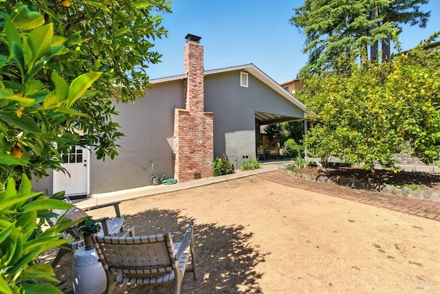 7 Arlene Ct, Petaluma, CA 94952 - back of property featuring stucco siding, a chimney, and a patio