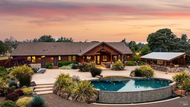 2570 Goodwin Ave, Penngrove, CA 94951 - rear view of property with a patio, an infinity pool, and stone siding