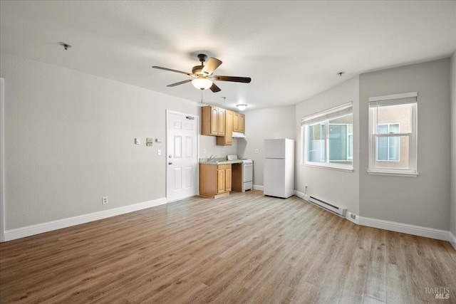 963 B St, Hayward, CA 94541 - unfurnished living room with a baseboard heating unit, light wood-style flooring, and a ceiling fan