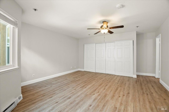 963 B St, Hayward, CA 94541 - unfurnished bedroom featuring baseboard heating, light wood-type flooring, and multiple windows