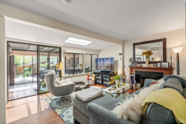 128 Walnut Ave, Mill Valley, CA 94941 - living area with wood finished floors, a skylight, and a fireplace