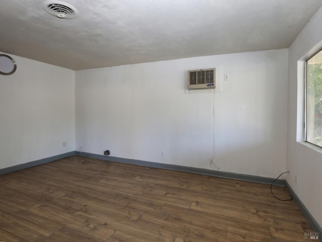 15190 Highlands Hbr, Clearlake, CA 95422 - empty room with a wall mounted air conditioner and dark wood-style flooring