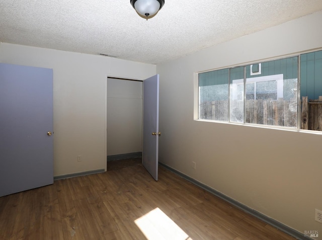 15190 Highlands Hbr, Clearlake, CA 95422 - unfurnished bedroom with wood finished floors, a closet, and a textured ceiling