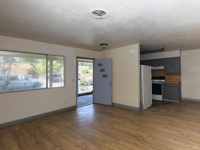 15190 Highlands Hbr, Clearlake, CA 95422 - unfurnished living room featuring baseboards and light wood-type flooring