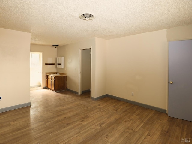 15190 Highlands Hbr, Clearlake, CA 95422 - empty room featuring wood finished floors and a textured ceiling