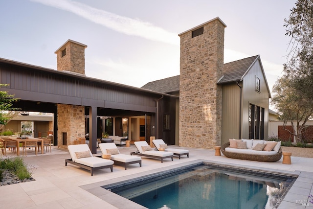 106 Vintners Ct, Napa, CA 94559 - rear view of house featuring a chimney, a patio area, an outdoor pool, and outdoor lounge area