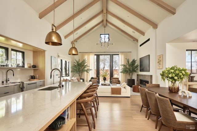 106 Vintners Ct, Napa, CA 94559 - kitchen with high vaulted ceiling, light stone counters, light wood finished floors, beamed ceiling, and hanging light fixtures