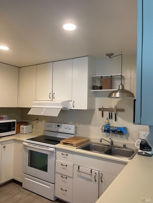 105 Virginia Ave Unit 1, Sebastopol, CA 95472 - kitchen featuring white appliances, light countertops, white cabinetry, under cabinet range hood, and recessed lighting