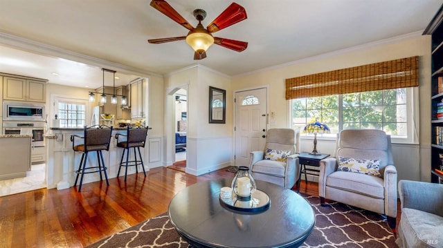 418 W Cotati Ave, Cotati, CA 94931 - living room featuring ceiling fan, wood finished floors, a wainscoted wall, ornamental molding, and arched walkways