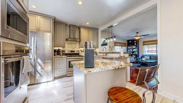 418 W Cotati Ave, Cotati, CA 94931 - kitchen featuring stainless steel appliances, wall chimney exhaust hood, a peninsula, a ceiling fan, and recessed lighting