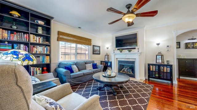 418 W Cotati Ave, Cotati, CA 94931 - living room with a ceiling fan, wood finished floors, ornamental molding, a glass covered fireplace, and arched walkways