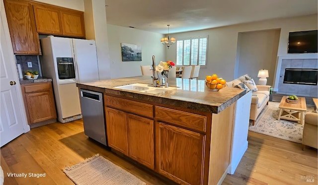 27 Via La Morra, American Canyon, CA 94503 - kitchen with white refrigerator with ice dispenser, stainless steel dishwasher, light wood-type flooring, open floor plan, and a tile fireplace