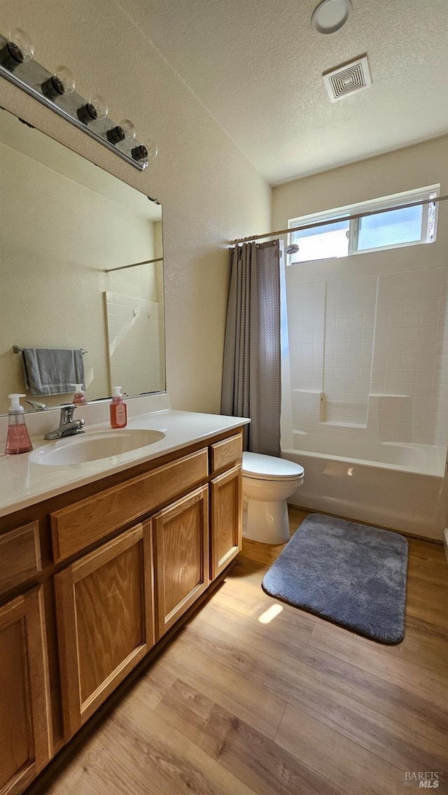 27 Via La Morra, American Canyon, CA 94503 - bathroom featuring wood finished floors, shower / tub combo with curtain, vanity, and a textured ceiling